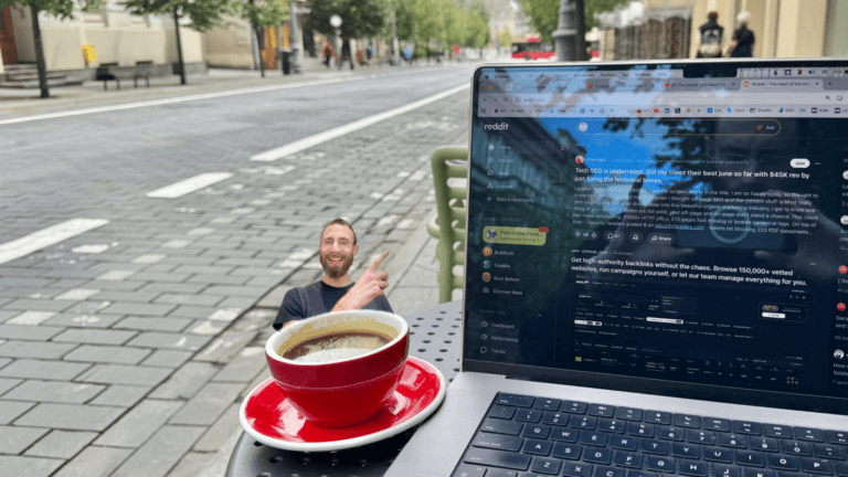 Laptop displaying Reddit discussions at an outdoor café with Edward Sturm pointing toward the screen, representing researching Reddit topics and identifying Reddit keyword opportunities for SEO.