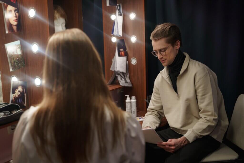 An actor and actress reading aloud to each other