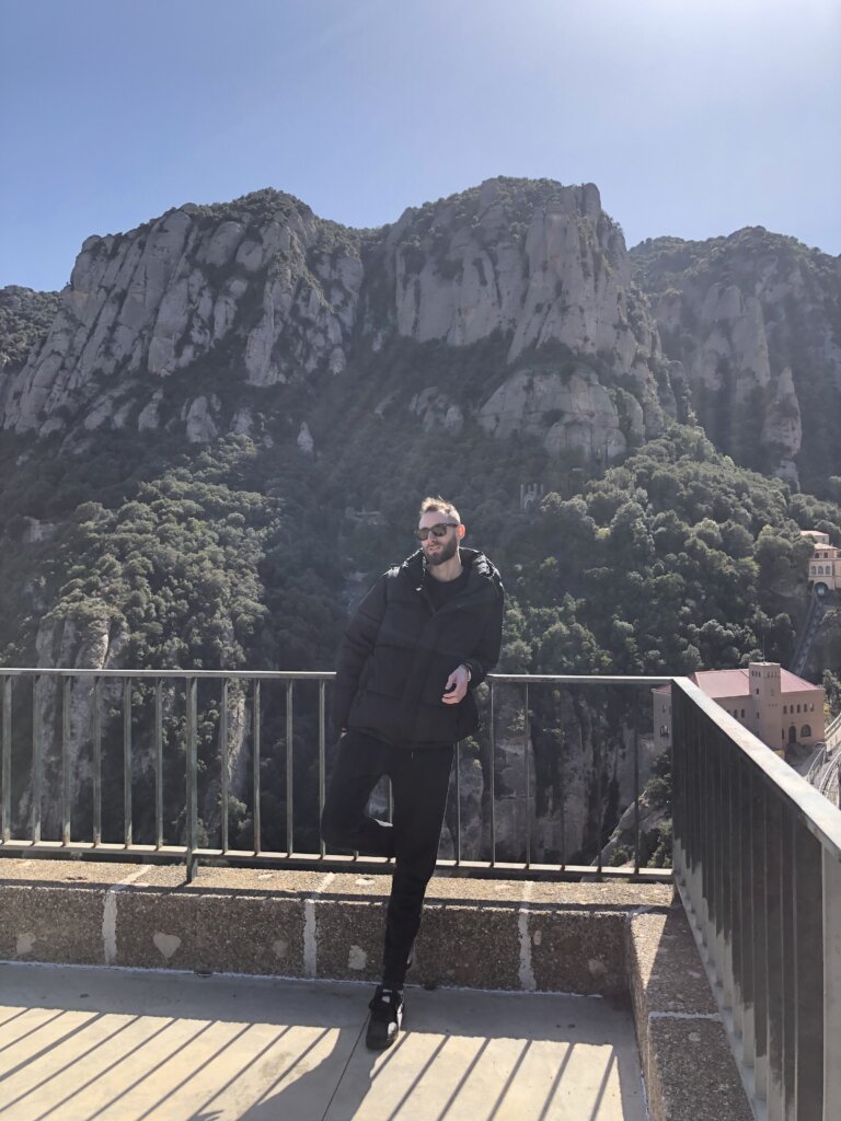 Edward Sturm in a winter coat at the Santa Maria de Montserrat Abbey in Montserrat, Spain. Photo taken in 2023.