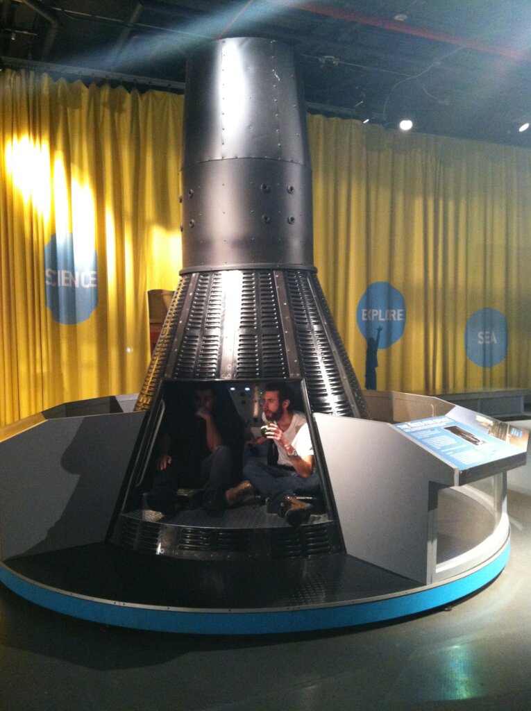 Edward Sturm and Brett Cohen at a space shuttle exhibit during a party on the USS Intrepid Aircraft Carrier in NYC, 2014.