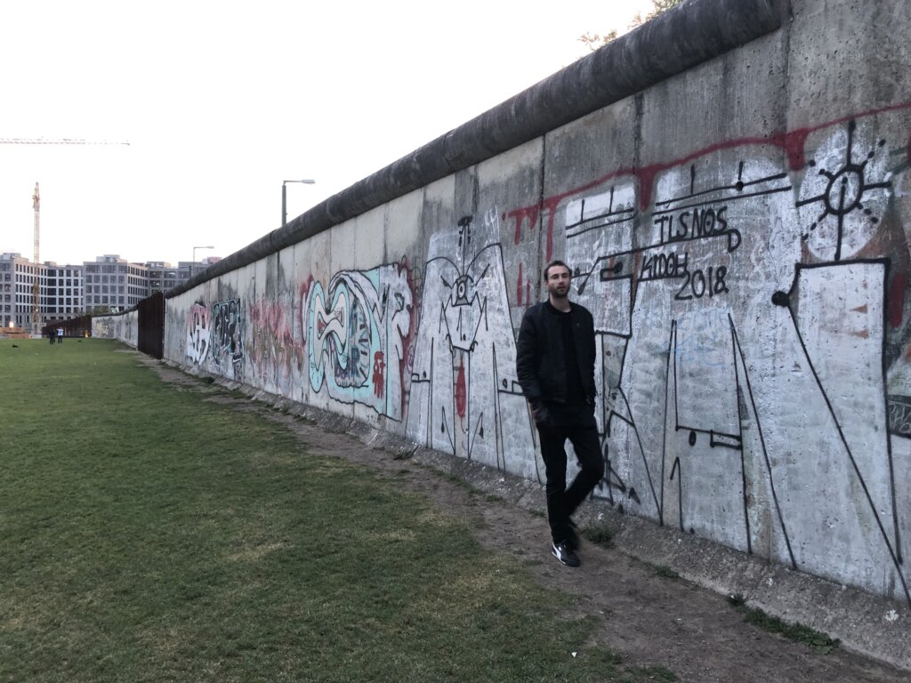 Edward Sturm walking in front of the Berlin Wall in 2019.