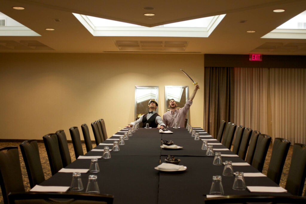 Edward Sturm with a sword and Michael Sorace - charging into action - in a boardroom at The Revere Hotel in Boston, 2013.