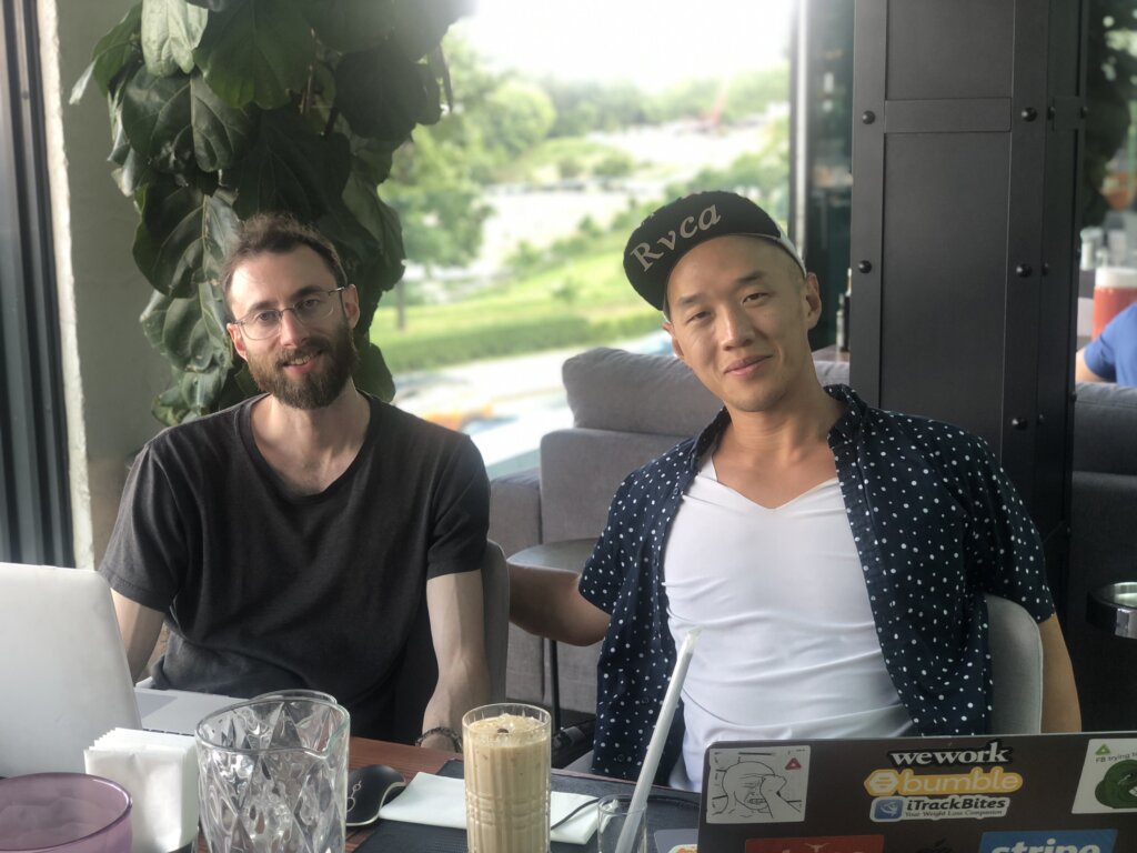 Edward Sturm and Eli Cho working with their laptops at lunch in Kyiv, Ukraine in 2021.