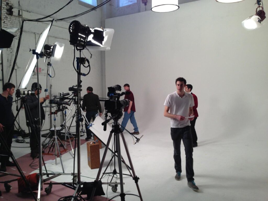 Edward Sturm on the set of his video, "Millennial High Art." Michael Sorace stands in the background. Cameras are being prepared. Photo taken in New Jersey, 2014.