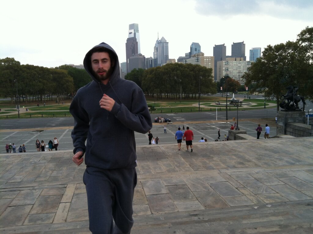 Edward Sturm in a sweatsuit, jogging up the stairs of the Philadelphia Museum of Art in 2013.