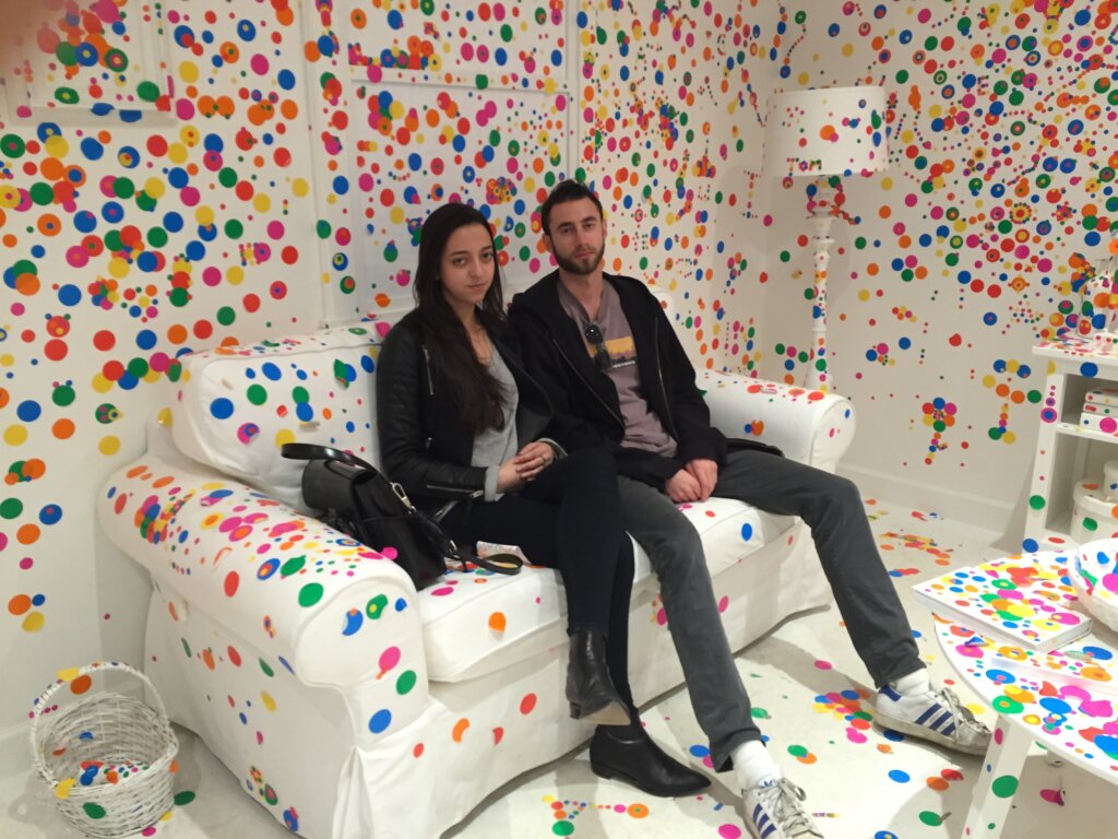 Edward Sturm and Sarah Sedky in a colorful dotted Yayoi Kusama installation in NYC, 2015.